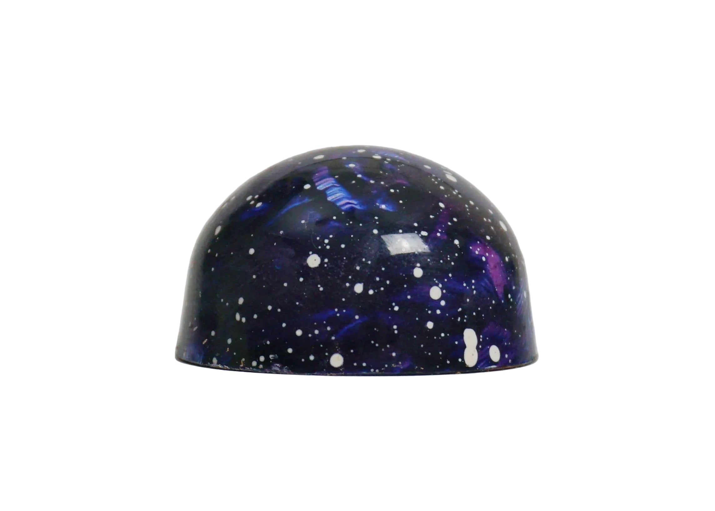 Dome-shaped chocolate bonbon with a galaxy design on a white background